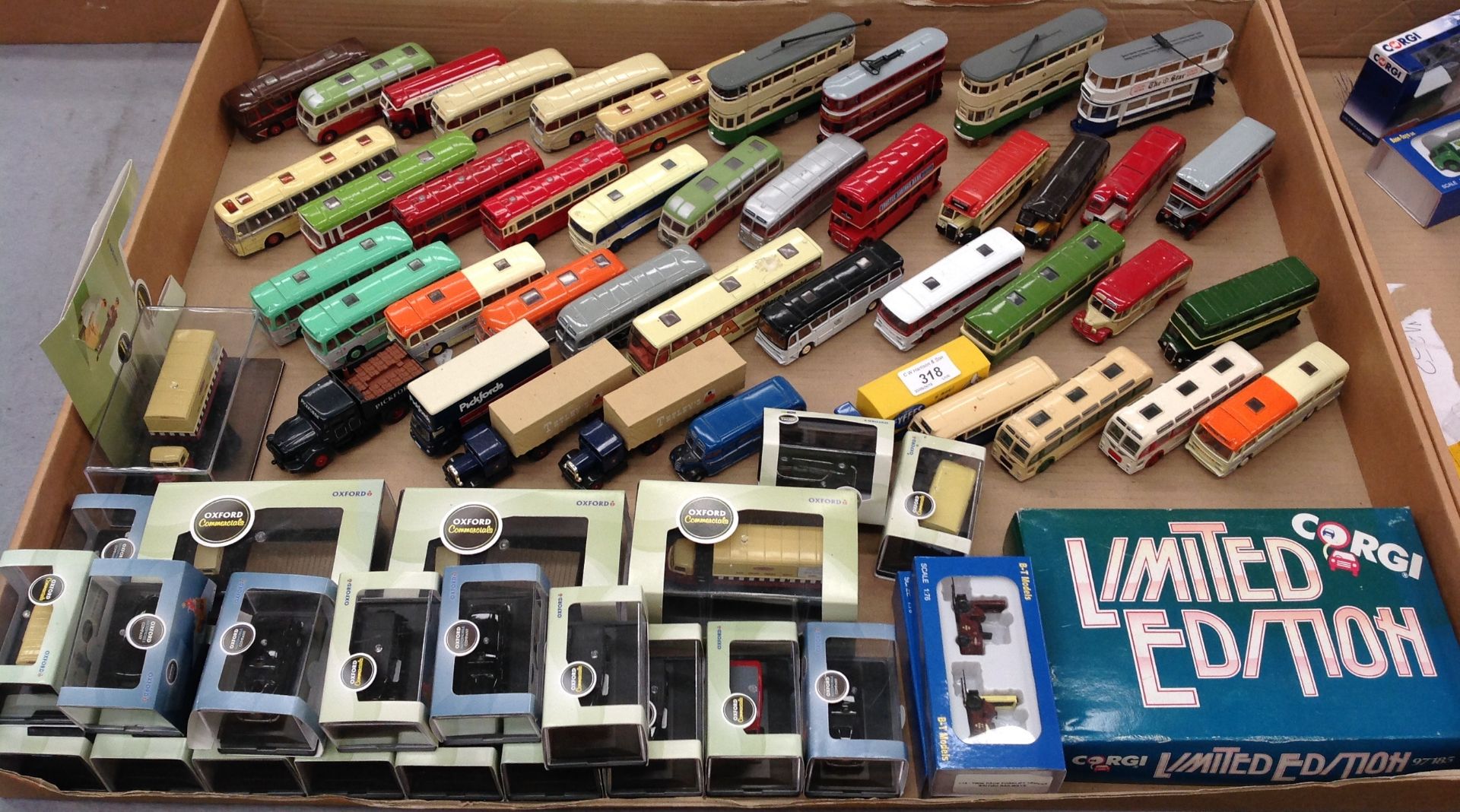Contents to tray approximately sixty five diecast miniature scale model buses, trams, commercials,