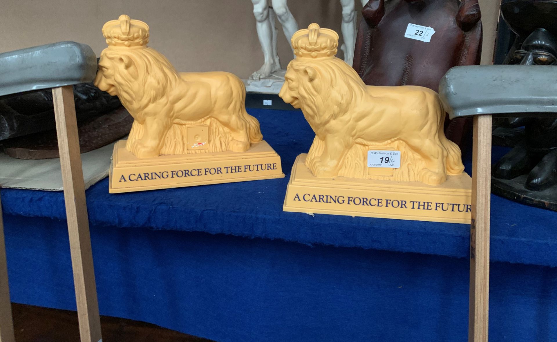 Two yellow plastic lion Poppy Appeal money boxes and a pair of wooden crutches