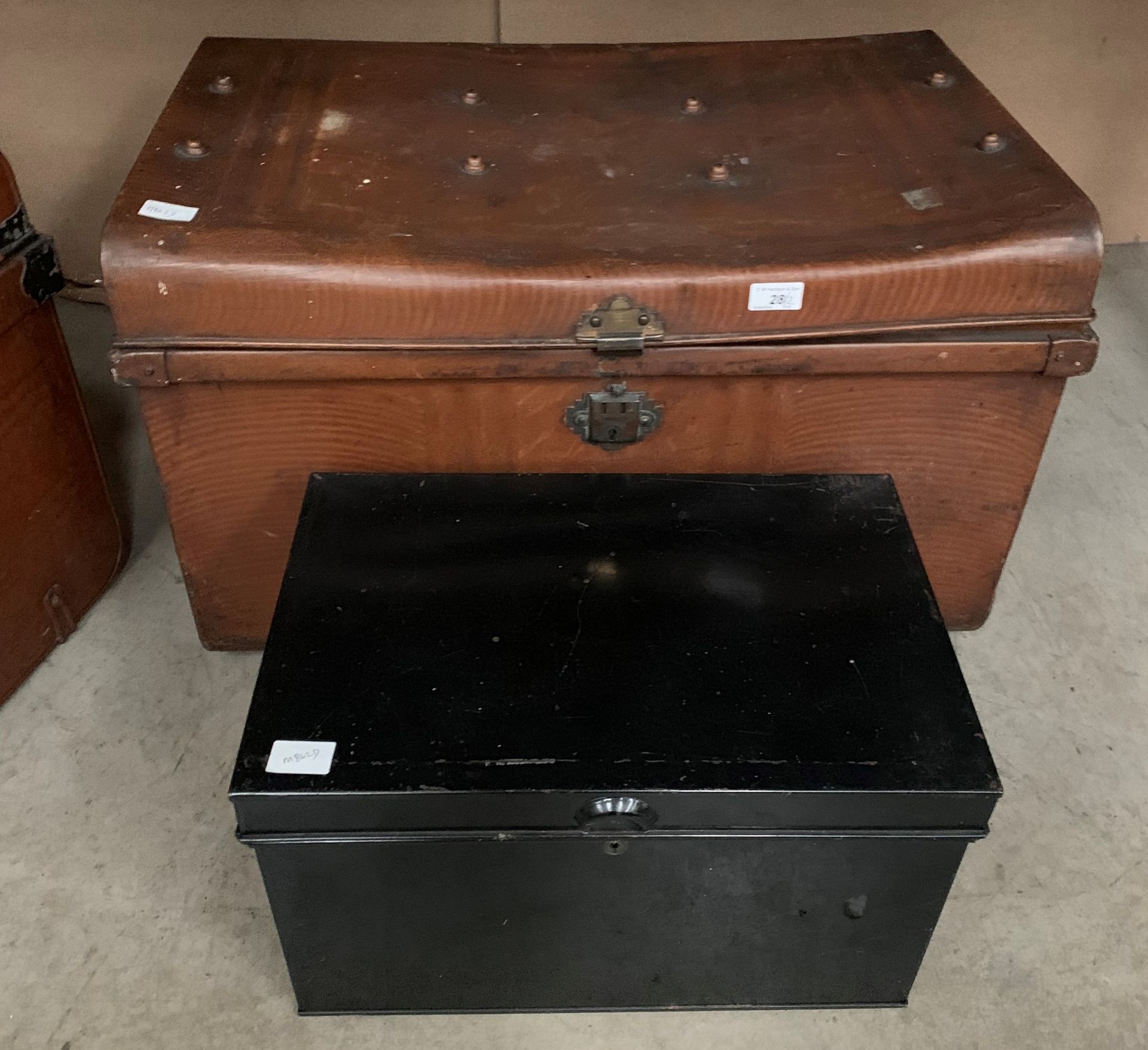 A brown and metal trunk 75 x 50 x 44cm high and a black metal deed box 47 x 30 x 27cm high complete