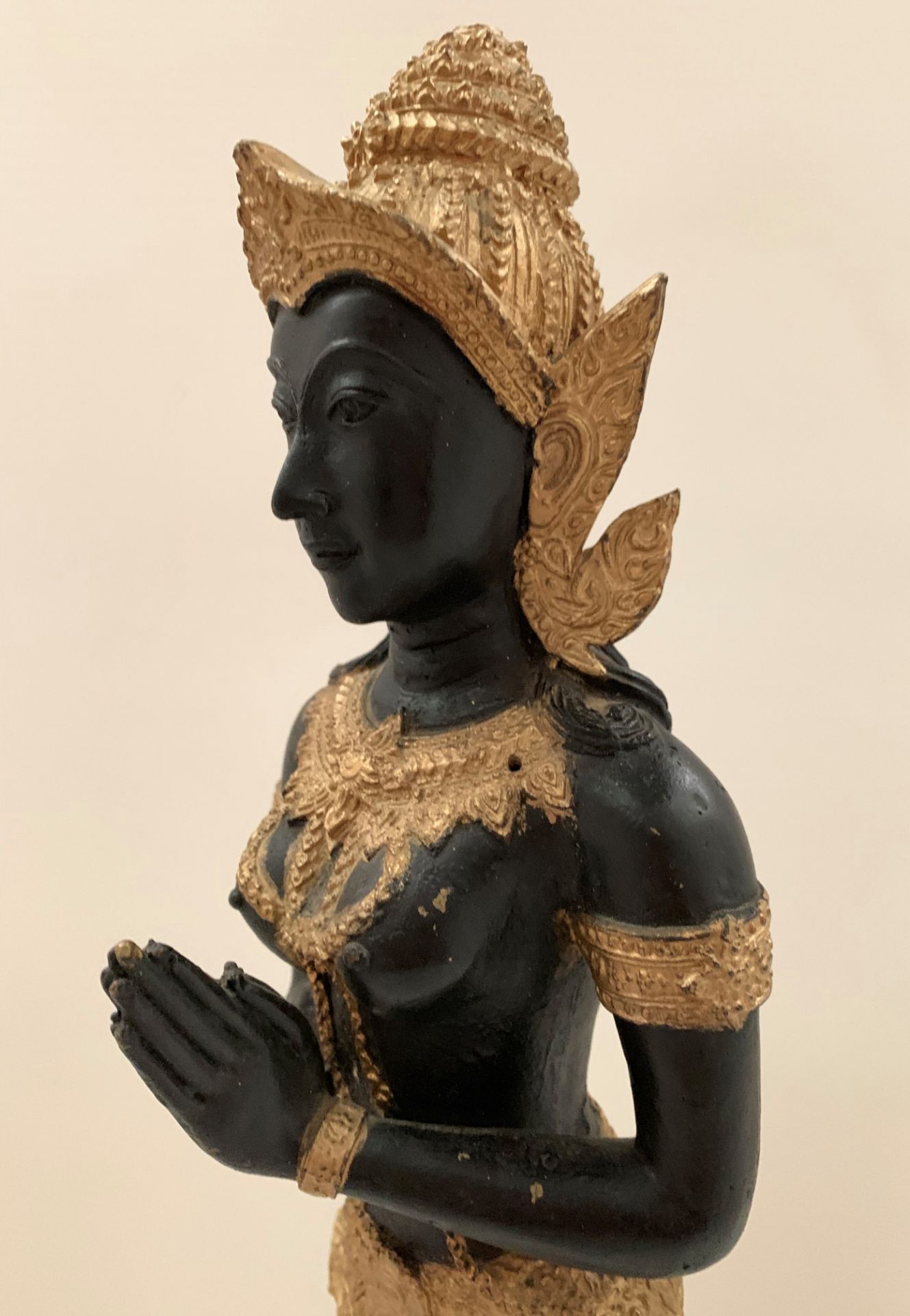 A gilt and black coloured metal figure of an oriental goddess at prayer on wood base - Image 2 of 2