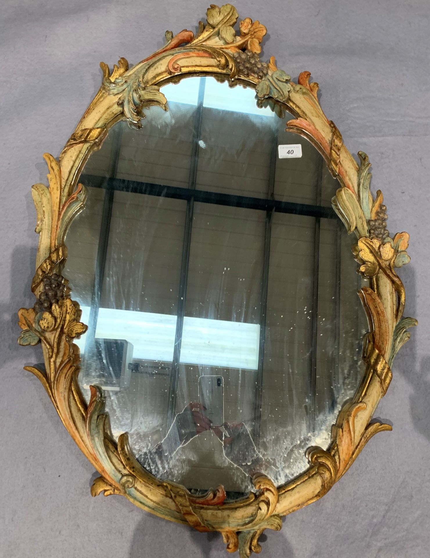 An ornate framed oval wall mirror 84 x 58cm