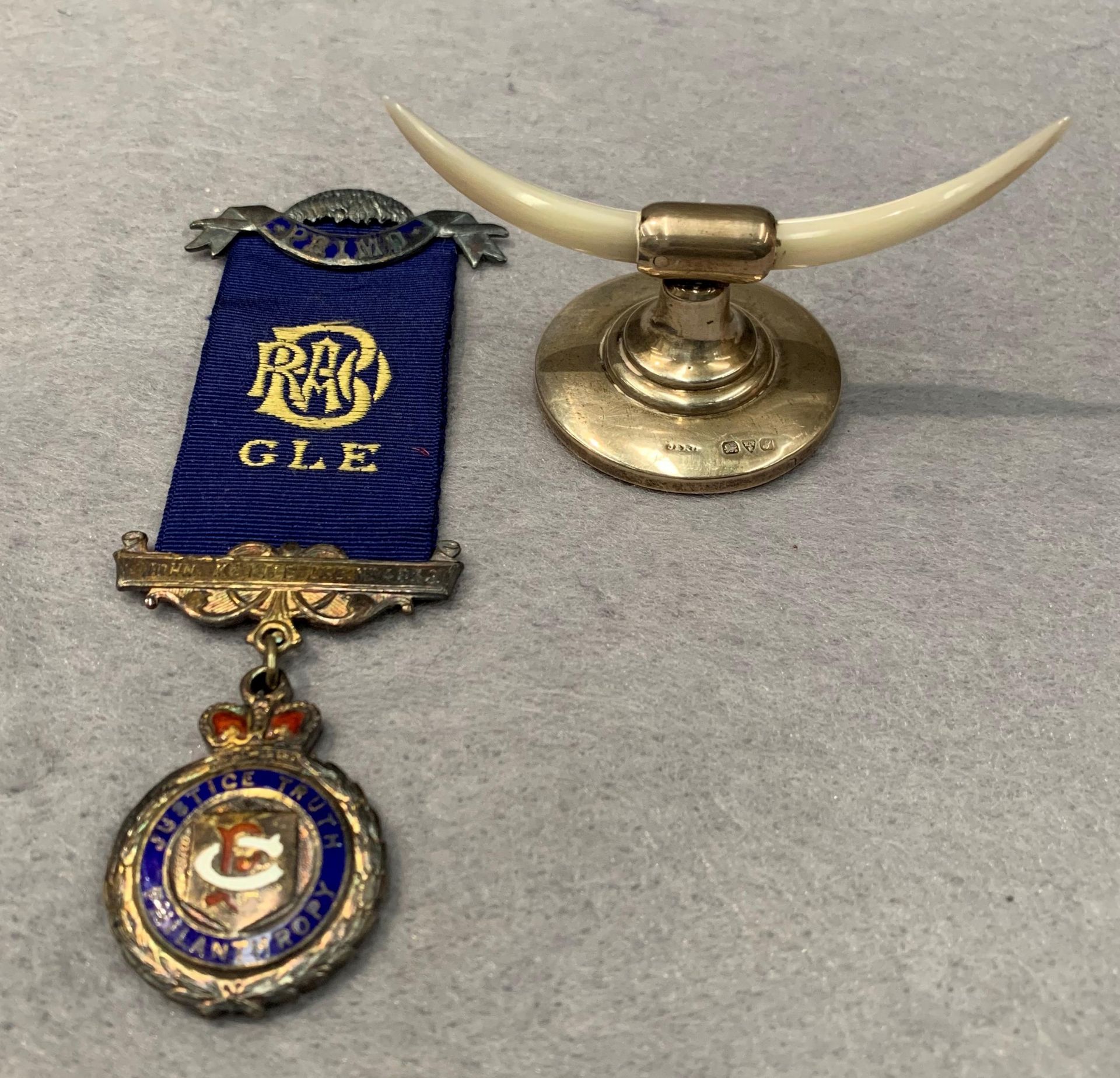 A silver John Kettle Buffalo Lodge medal and a silver and mother of pearl Buffalo horn ornament (2)
