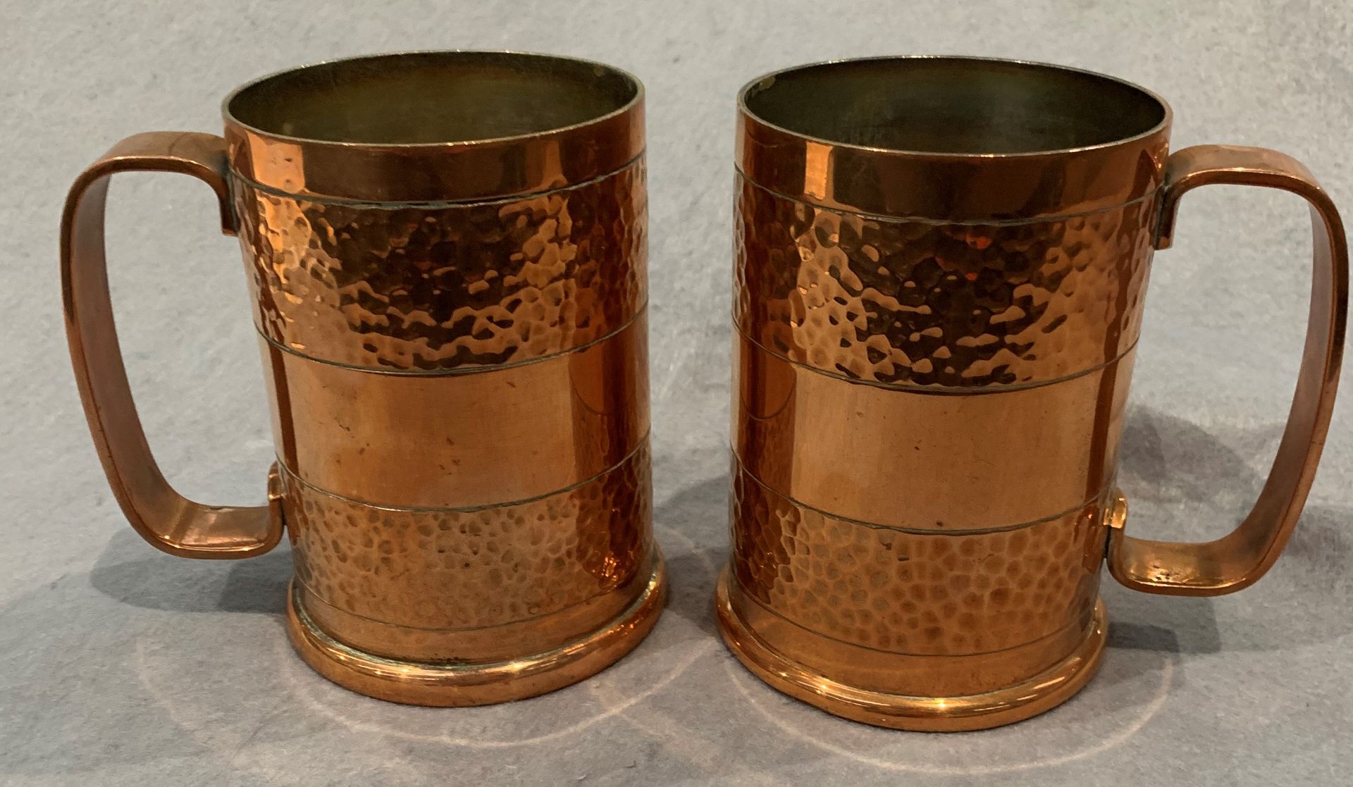 A pair of Richard Mead Rhodesian made copper tankards