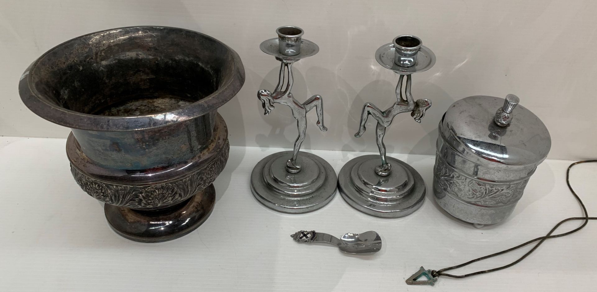 A pair of Art Deco chromium plated candlesticks as naked female dancers and two other chromium