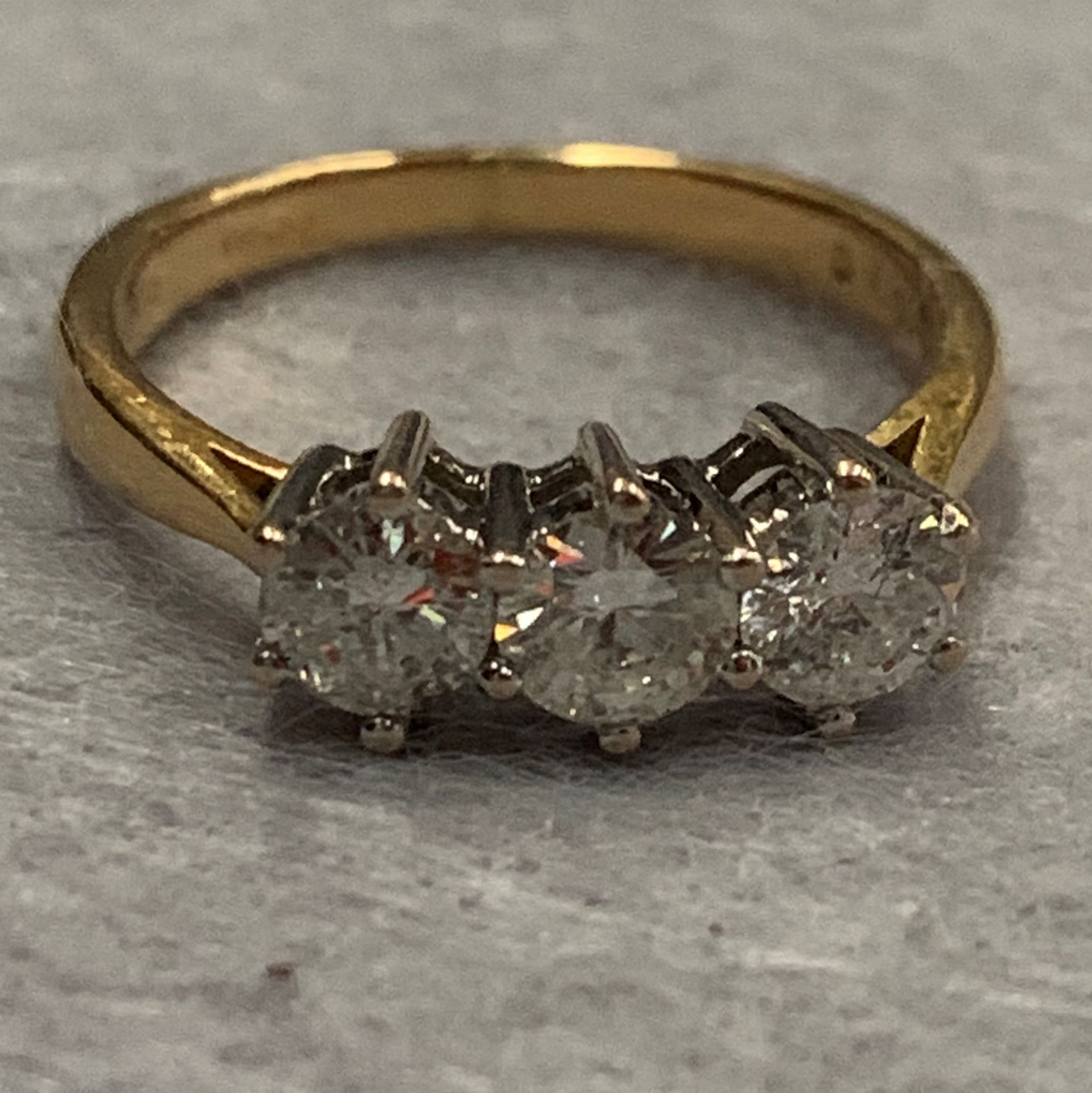 A ladies 18ct three stone diamond ring, yellow gold shank and white gold three stone head, 3 x 4.