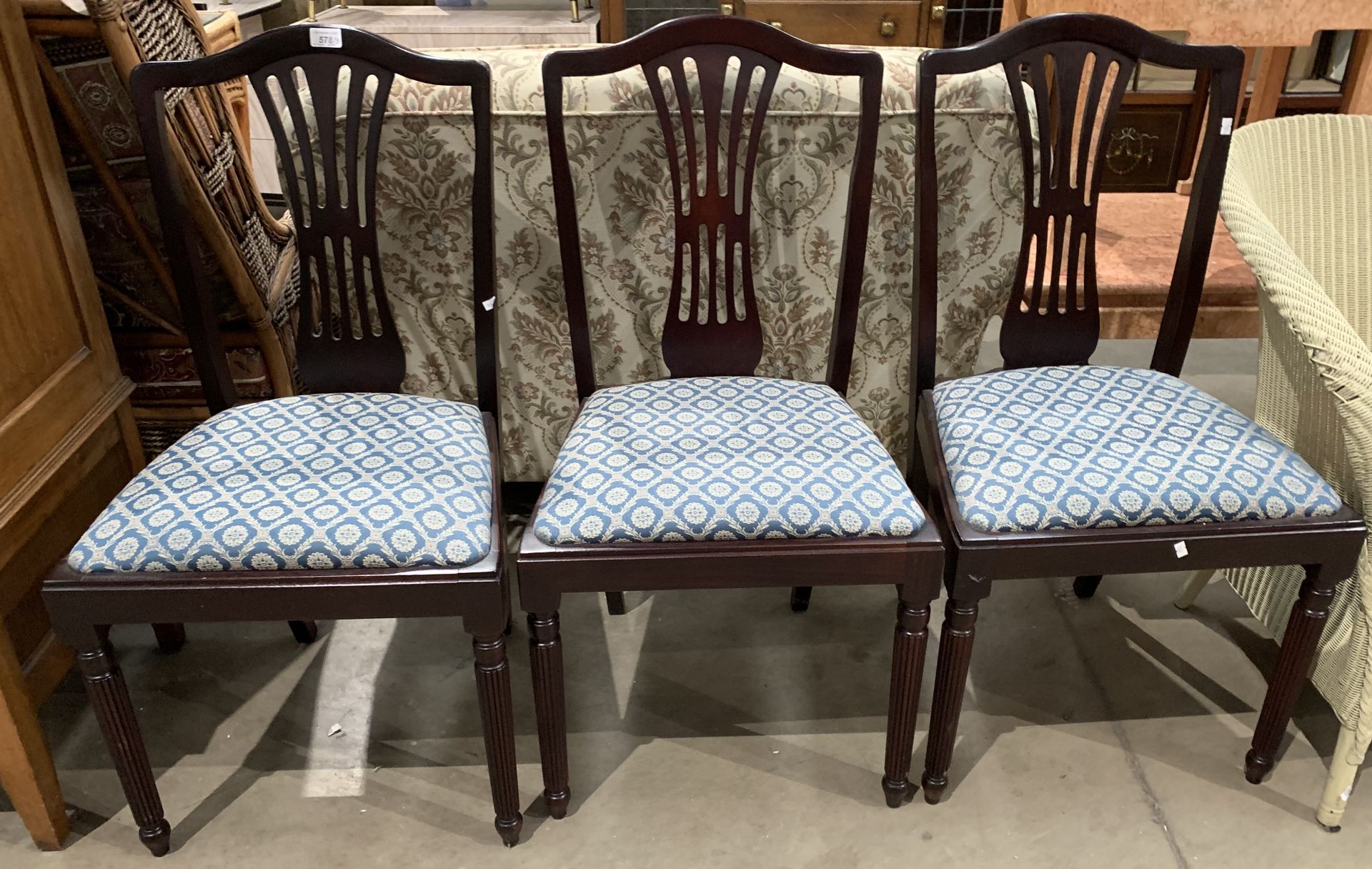 A set of three mahogany dining chairs with centre splat back and blue patterned upholstered seats