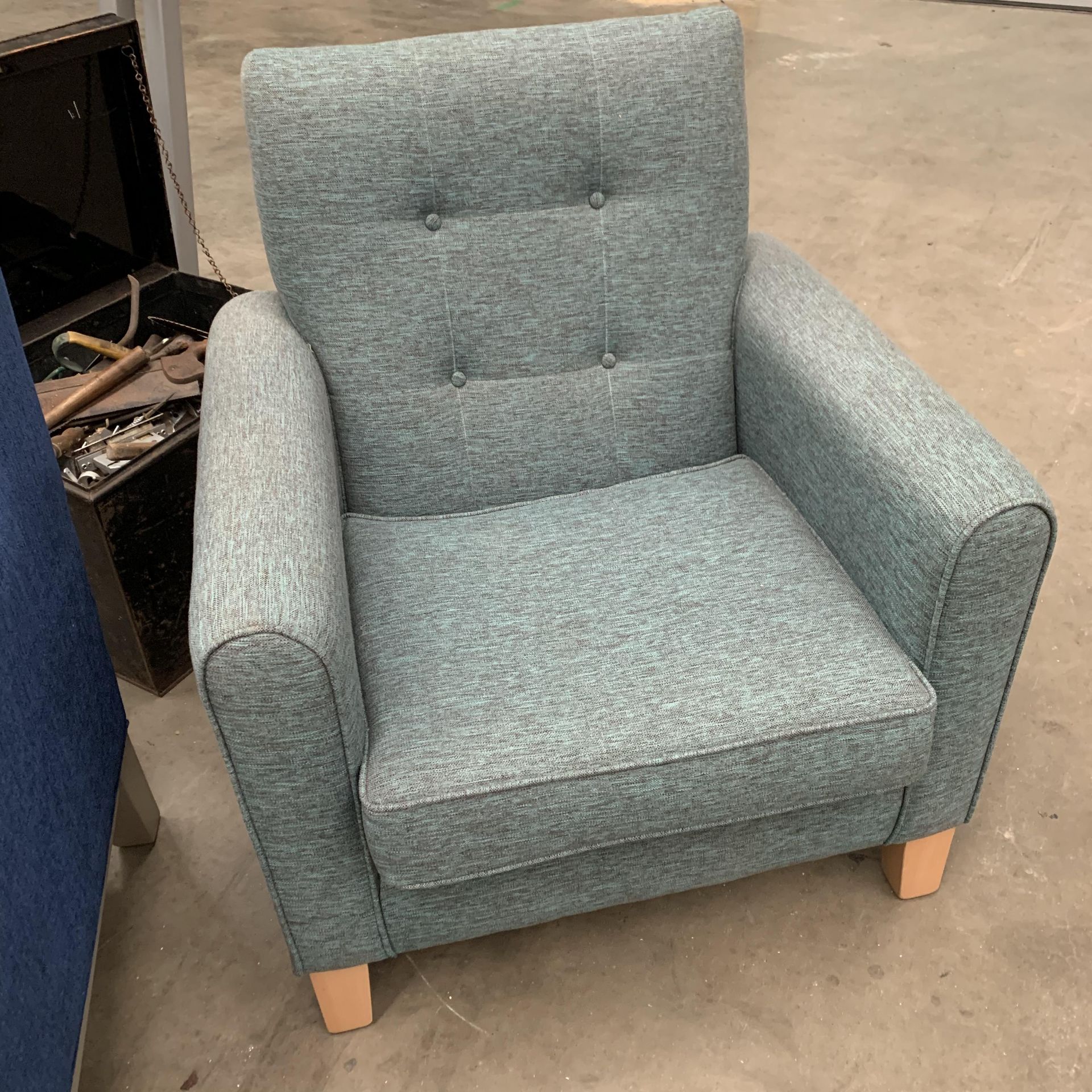 A green fabric upholstered armchair