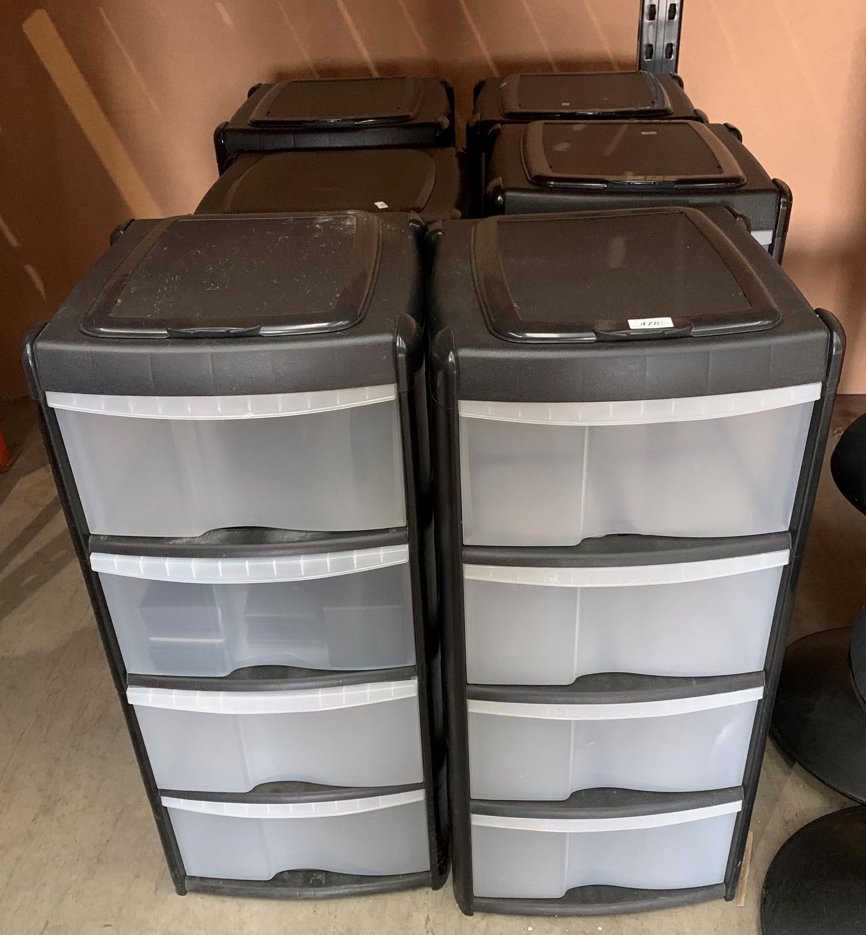 Six black plastic framed four drawer storage cabinets