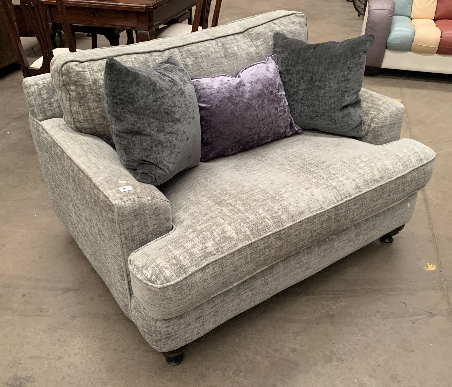 A Christopher Pratts grey cloth upholstered two seater settee with two dark grey and one purple