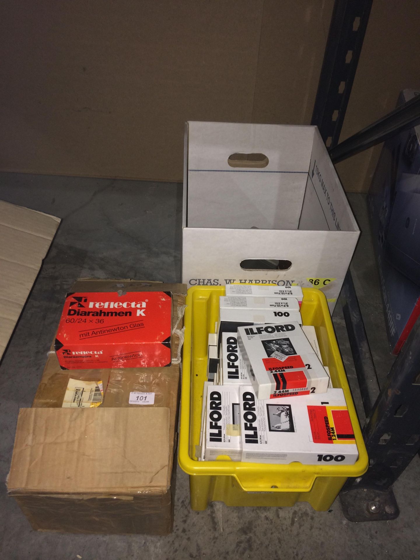 Contents to corner of rack - packs of Ilford photographic paper,