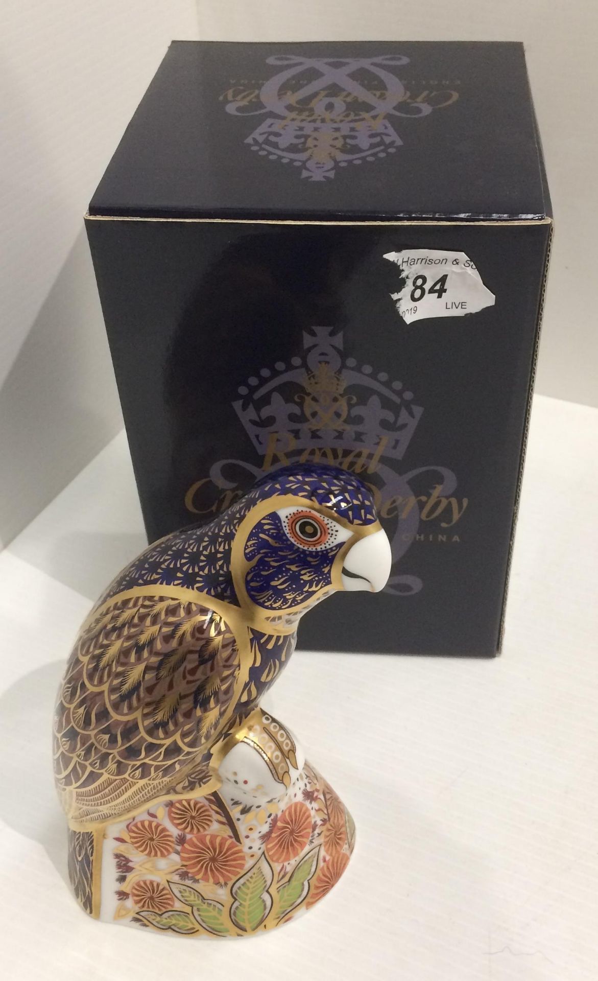 A Royal Crown Derby bone china Bronzed Winged Parrot paperweight - 16cm high,