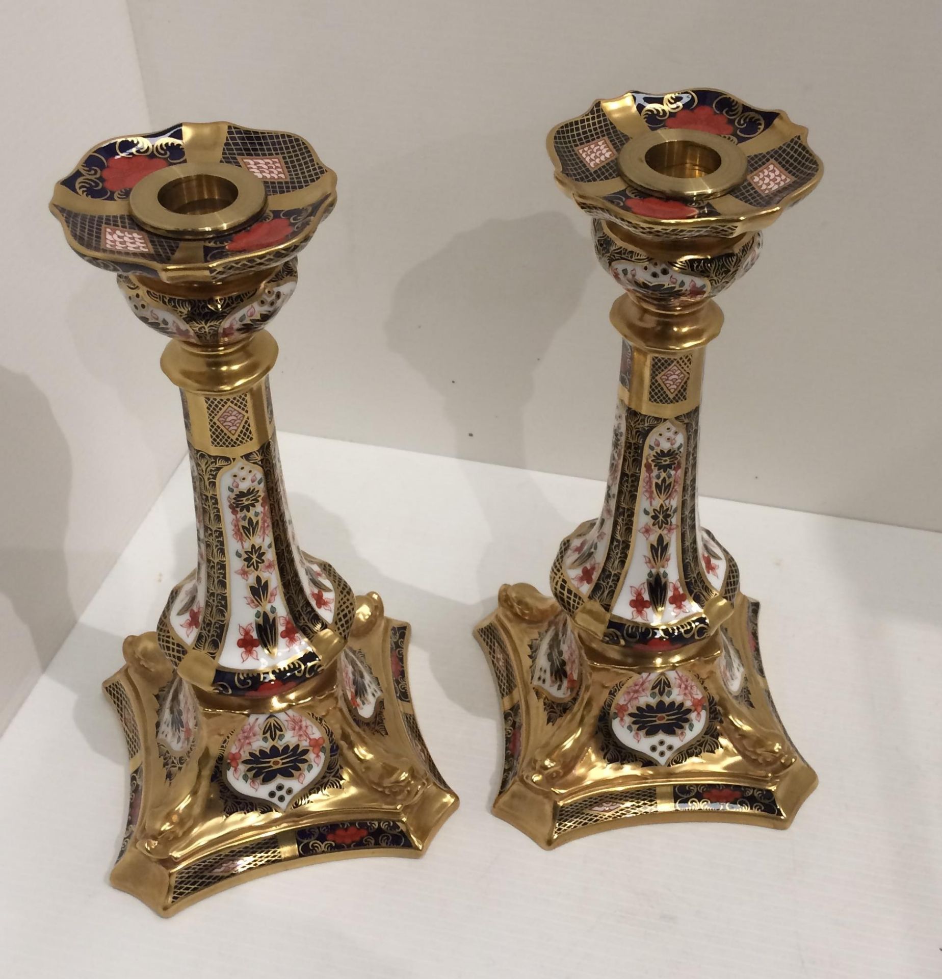 A pair of Royal Crown Derby bone china Old Imari pattern 1128 LIII candlesticks each 27cm high - no