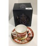 A Royal Crown Derby bone china MMI Golden Peony pattern cup and saucer (boxed)