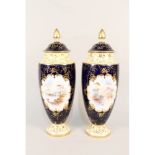 A pair of Coalport blue ground vases with painted reserves of Kilchurn Castle and Mount Venue,