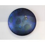 A Ditchfield Glasform mauve iridescent paperweight with a dragonfly embellishment