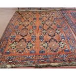 A Caucasian red ground carpet with geometric designs,