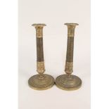 A pair of early 19th Century French gilt brass candlesticks with engine milled decoration to the