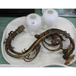 A pair of brass swan neck gas lights with bird and acanthus leaf decoration and milk glass shades