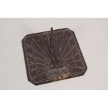 An early 20th Century brass sun dial engraved with equation of time chart,