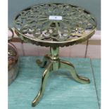 A heavy 19th Century brass trivet in the form of a tripod table with pierced circular top,