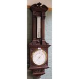 A carved oak barometer by Negretti & Zambra, No.