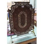 An Indian copper and brass fire screen with pierced floral decoration