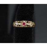 An 18ct gold ruby and diamond ring in ornate pierced setting,