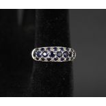 A 9ct gold ring set with multiple blue stones,