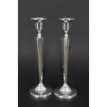 A pair of sterling silver candlesticks with adjustable apertures