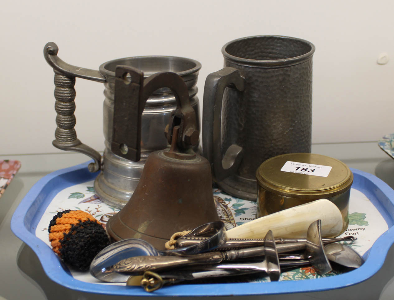 Two pewter tankards, brass bell,