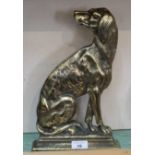 A brass doorstop in the form of a seated dog,