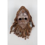 An African wooden mask with wool attachments