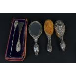 Three piece silver dressing table set comprising of mirror and two brushes,