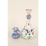 A 19th Century Isnik pottery floral decorated vase plus a small Middle Eastern blue decorated ewer