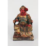 A Chinese polychrome wooden carving of a seated dignitary,