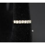 A 9ct gold seven stone diamond ring, approx 0.