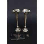 A pair of silver bud vases (dented),