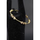 A yellow metal diamond set bangle marked 18ct, diamond weight approx 1.