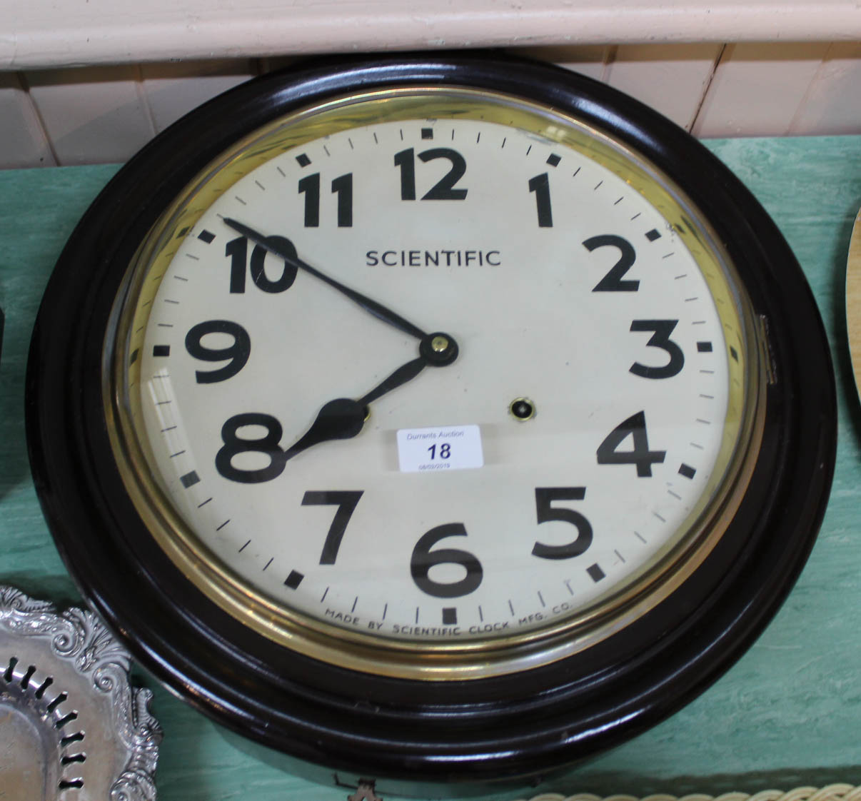 A circular Scientific Clock MFG Co wall clock