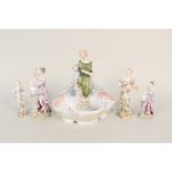 A continental porcelain floral and figure mounted dish plus four figures