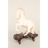 A Chinese ivory carving of a horse,