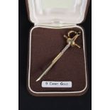 A 9ct gold brooch in the form of a sword set with a saphire