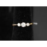 A yellow metal three stone diamond ring,