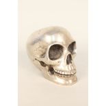 A silver plated skull with moveable mandible, signed Sumuiti,
