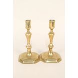 A pair of early 18th Century seamed brass candlesticks with octagonal shaped sockets,