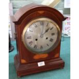 An Edwardian inlaid mahogany striking mantel clock