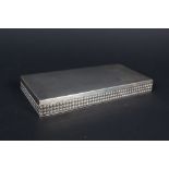 A continental white metal cigarette box with raised button border and plain top,