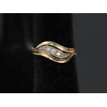 An 18ct gold five stone diamond ring in 'wave' style setting,