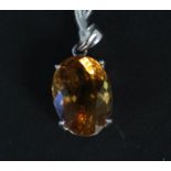 An 18ct white gold pendant set with orange stone (possibly a citrine)