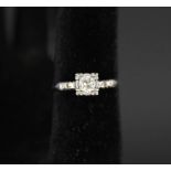 A white metal ring set with solitaire diamond,